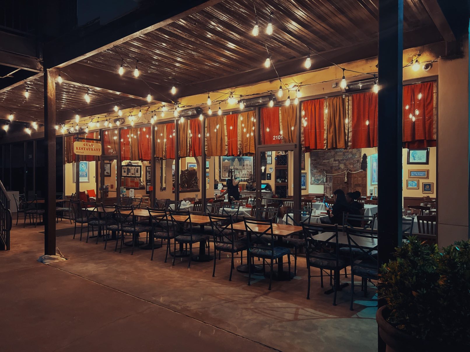 More various dishes being served at Guru Indian Restaurant outside seating area at Guru Indian Restaurant